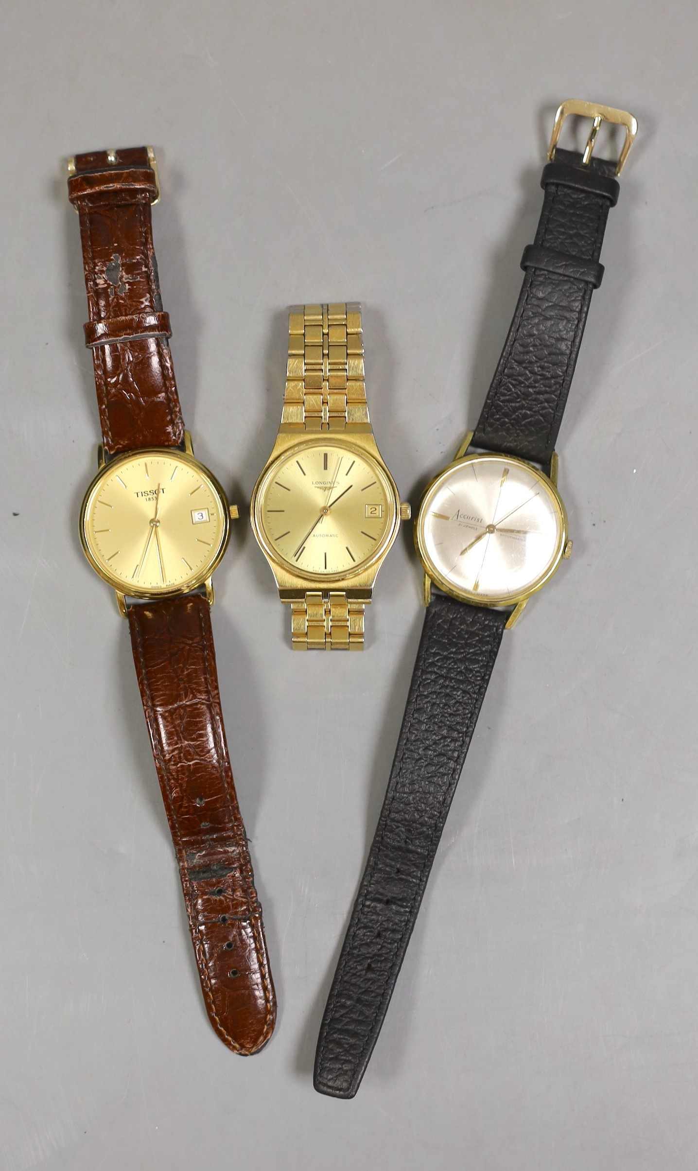 Three assorted gentleman's wrist watches, including a steel and gold plated Longines automatic, Tissot and Accurist.